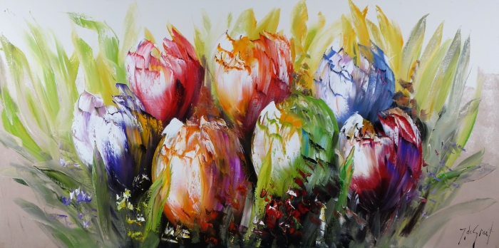 Kleurrijke tulpen in levendige tinten zoals rood, paars, en geel, omringd door groene bladeren en een zachte achtergrond.