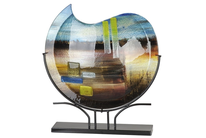 Kleurrijke glazen schaal met abstracte patronen van blauw, groen en bruin, steunend op een zwarte metalen standaard.